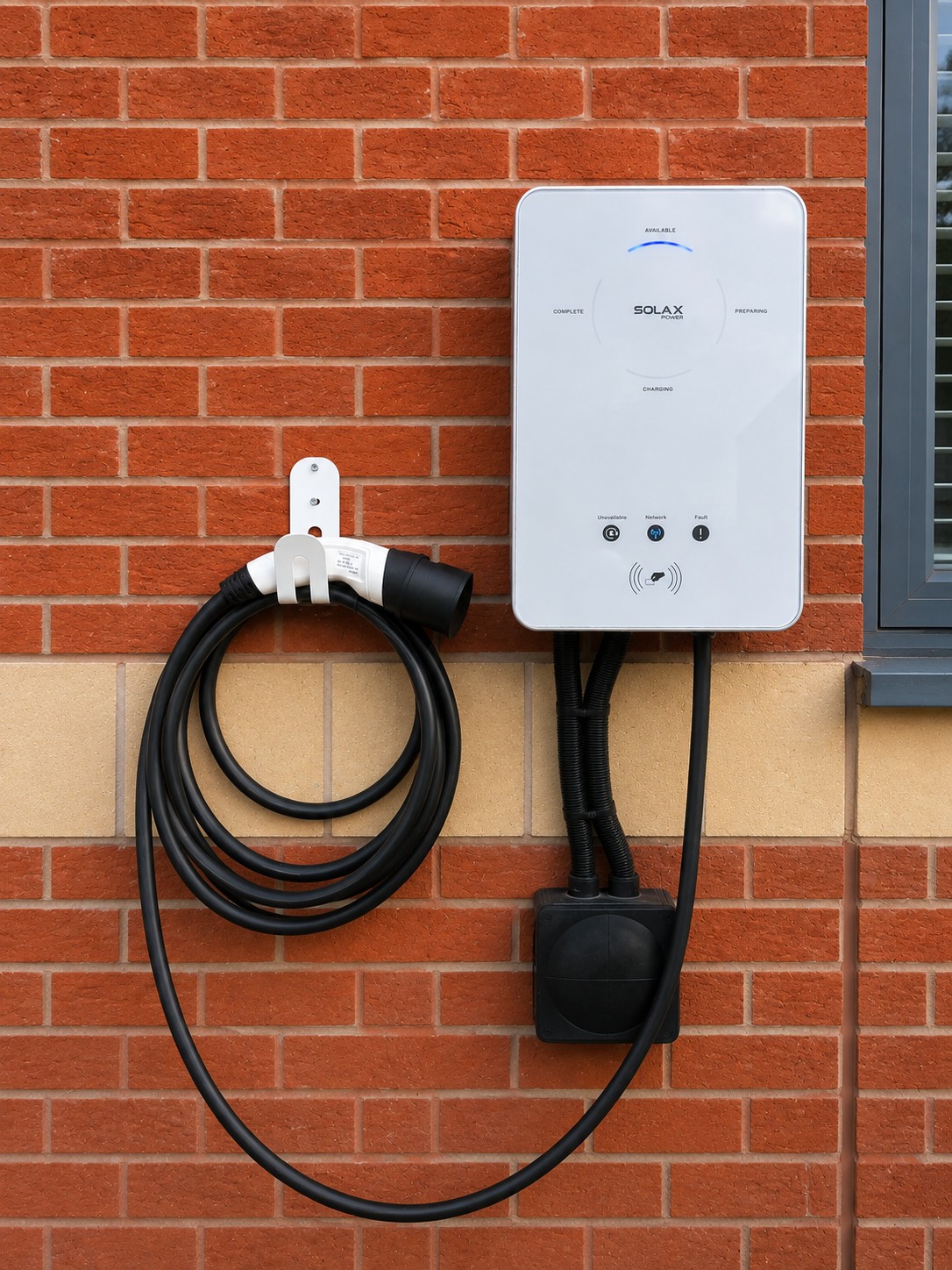 SolaX EV charger mounted on a brick wall